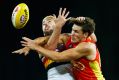 In a tangle: David Swallow of the Suns contests posession with one of the Crows' best, Rory Atkins