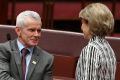 Senator Malcolm Roberts shakes hands with Senator Michaelia Cash after the Fair Work (Registered Organisations) ...