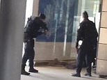 Police were seen leading a man away at the Gare du Nord station in Paris this afternoon