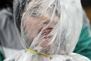 A Nepalese activist stands wrapped in a plastic sheet with a rope tied around her neck as a mark of protest against air pollution on Earth Day in Kathmandu, Nepal, Saturday, April 22, 2017. Kathmandu is considered one of the most polluted cities in the world.