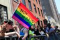 A woman holds a rainbow flag during the NYC Pride Parade in New York. 