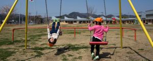 Children ride swings at the nursery school in Naraha, Japan.