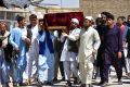 Men carry the coffin of one of the victims of Friday's attack at a military compound in Mazar-i-Sharif, northern Afghanistan.