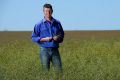 Farmer Brett Hosking in his canola field near Quambatook. 