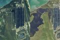 Satellite images of the Abbot Point coal terminal and neighbouring wetlands. Before Cyclone Debbie on the left and ...