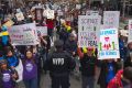 Demonstrators pass a policeman in the March for Science in New York.