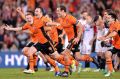 Sweet victory: Brisbane celebrate their shootout win.