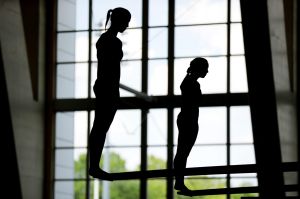 In this Friday, April 14, 2017, Anne Fowler, left, and Carolina Sculti prepare to jump off the 3-meter springboard ...