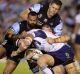 Teamwork: Jarrod Wallace of the Titans is gang-tackled by the Sharks.