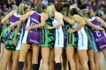 Show of unity: Players from the Firebirds and the Fever embrace before their clash at Brisbane Entertainment Centre.