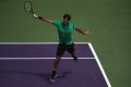 Roger Federer of Switzerland plays a backhand in his match against Rafael Nadal of Spain in the final of the Miami Open.