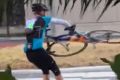 Blowing a gale: A cyclist battles to hold onto his bike against the wind.