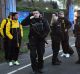 Dortmund's Marcel Schmelzer, third from right, talks to police officers outside the team bus after the explosion.