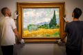 NGV staff hang van Gogh piece, A wheatfield with cypresses, ahead of the <i>Van Gogh and the Seasons</i> exhibition.