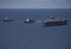 File - The Arleigh Burke-class guided-missile destroyer USS Michael Murphy (DDG 112), left, and the Ticonderoga-class guided-missile cruiser USS Lake Champlain (CG 57) are underway with the aircraft carrier USS Carl Vinson, Indian Ocean, 14 April, 2017.