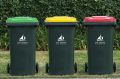 Pictures shows Lake Macquarie's three bins. The green-lid bin is for green waste, the red-lid bin for general waste, the ...