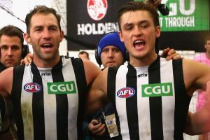 Darcy Moore sings the club song with former teammate Travis Cloke after a win in 2016. 