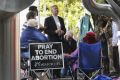 A prayer vigil outside a Canberra abortion clinic before it was made illegal.