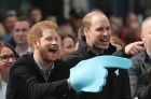 Britain's Prince Harry, the Duke of Cambridge, right, and his brother Prince Harry urge on runners at the Head Together ...