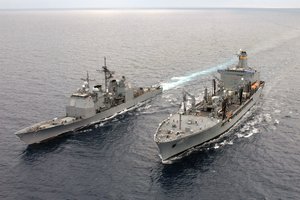 The guided missile cruiser USS Lake Champlain (CG 57), left, completes a replenishment at sea with the Military Sealift Command (MSC) oiler USNS Pecos (T-AO 197).