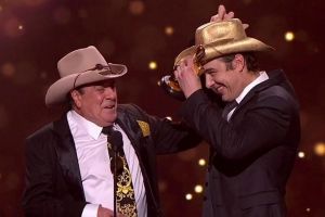 Molly Meldrum gifts Samuel Johnson with a golden Stetson.