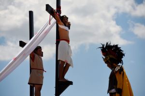 Reuben Enaje (right cross) playing the role of Jesus during the Passion Play a re-enactment of Christs crucifixion, on ...