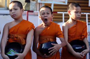 One of novice Buddhist monks yawns during a merit in Bangkok, Thailand, Wednesday, April 19, 2017. Thai men are expected ...