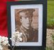 A portrait of Lance-Corporal Vivian George Taylor rests against his gravestone as it awaits rededication at the ...