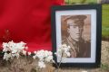 A portrait of Lance-Corporal Vivian George Taylor rests against his gravestone as it awaits rededication at the ...