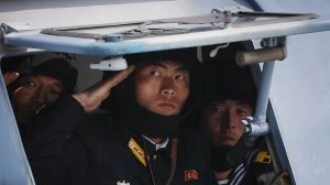 North Korean soldiers look out of a military vehicle as they are paraded on the Kim Il-sung Square during a military ...