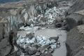 A close-up view of the ice-walled canyon at the terminus of the Kaskawulsh Glacier, with recently collapsed ice blocks, ...