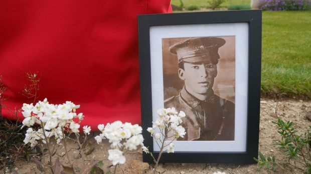 A portrait of Lance-Corporal Vivian George Taylor rests against his gravestone as it awaits rededication at the ...