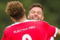 Canberra FC's Thomas James is hugged by a teammate after scoring a goal.