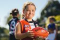 Ainslie player Elise Doherty, 7, is forming part of the junior footy resurgence.
