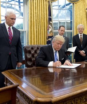 US President Donald Trump signs an executive order reinstating the gag rule prohibiting receivers of aid from discussing ...