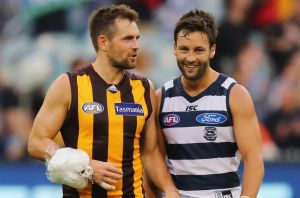   Luke Hodge of the Hawks, talks to Jimmy Bartel of the Cats, after last year's match between the fierce rivals.