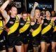 Yellow and black: Richmond players belt out the song on Anzac Eve.