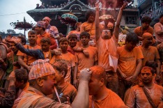 A group of devotees throw vermillion powder to other devotees in celebration of the new year.