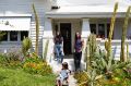 Sarah, Tabitha and Andy in their whitewashed California bungalow.
Andy planted the thriving cactus garden.