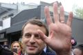 Centrist candidate Emmanuel Macron waves to supporters.