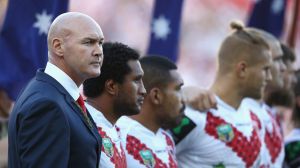 Dragons coach Paul McGregor watches on during pre-game Anzac Day commemorations.