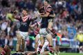 Golden moment: Michael Gordon jumps on Mitchell Pearce in celebration after the field goal.