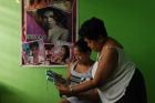 In hiding Elena de Chavez, right, with her daughter Arriana de Chavez look at a photo of her transgender daughter Heart.