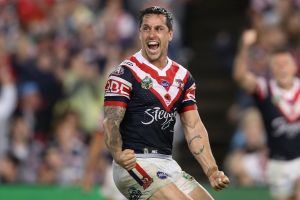 SYDNEY, AUSTRALIA - APRIL 25: Mitchell Pearce of the Roosters celebrates kicking a field goal to claim golden point ...