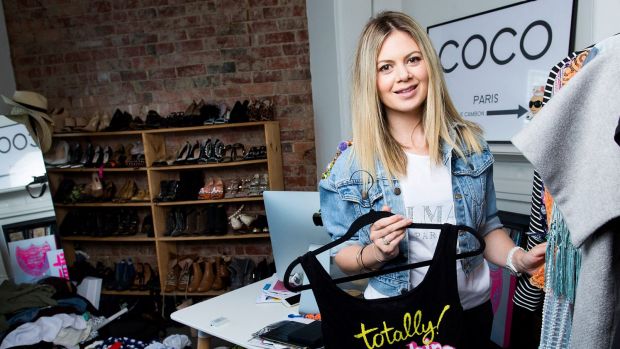 Jess Dempsey amongst her huge collection of clothing, which she plans to sell on Saturday. 