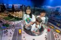Caitlin, 11, Chloe, 8 and Owen, 10 enjoy a lego view of Melbourne at the opening of the Legoland Discovery Centre. 