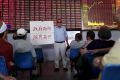 An investor holds a board showing "government saves the market so that investors will be happy" in Shanghai in 2015.  ...