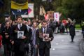 Son and father Paul (left) and Grant Holland (right) marched in the alternative Anzac Day parade near the Shrine of ...