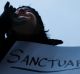 Demonstrators chant against US President Donald Trump's executive order  on "sanctuary cities" in Cincinnati in January. 