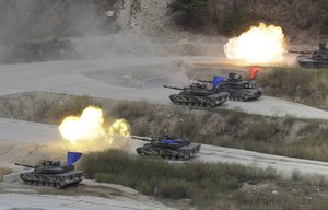 In this April 21, 2017 photo, South Korean and U.S. Army's tanks fire during a South Korea-U.S. joint military live-fire drill at Seungjin Fire Training Field in Pocheon, South Korea, near the border with the North Korea.